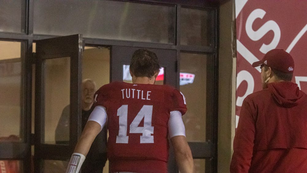 Redshirt junior quarterback Jack Tuttle heads to the locker room during the fourth quarter on Oct. 25, 2021, at Memorial Stadium. Tuttle is week to week with an injury.