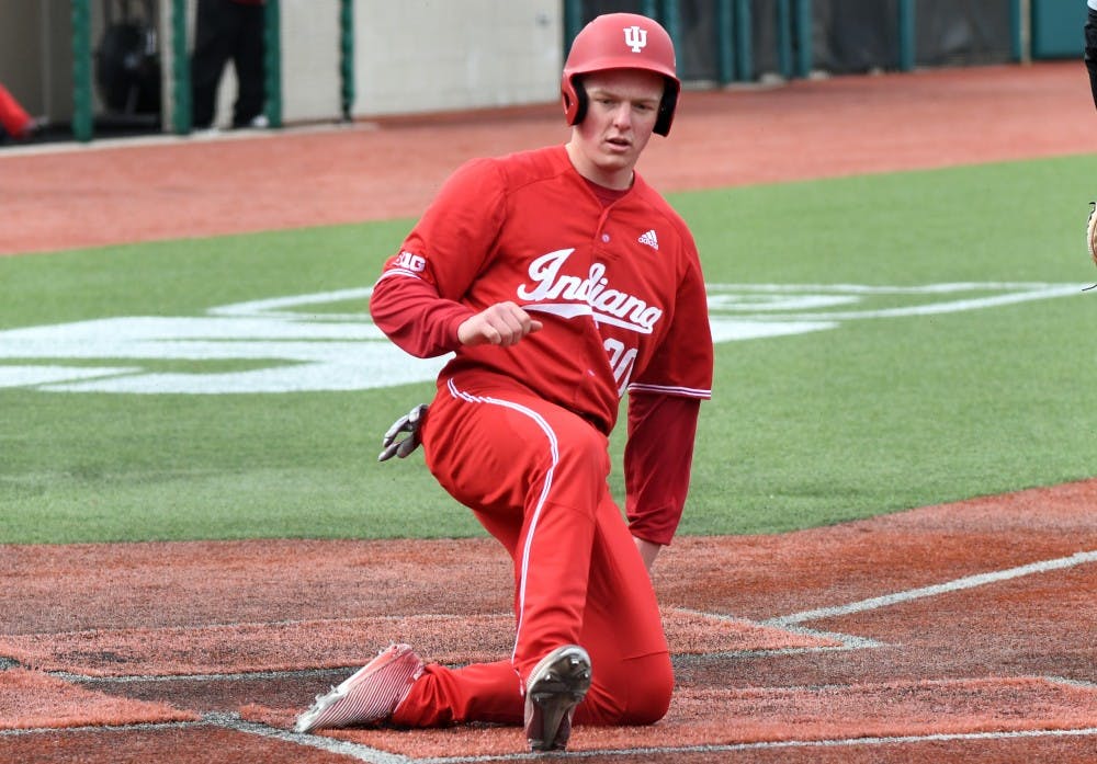 <p>Sophomore infielder Scotty Bradley slides into home plate against Purdue on April 8 at Bart Kaufman Field. The Hoosiers are currently predicted as a three seed in the most recent postseason projections.</p>