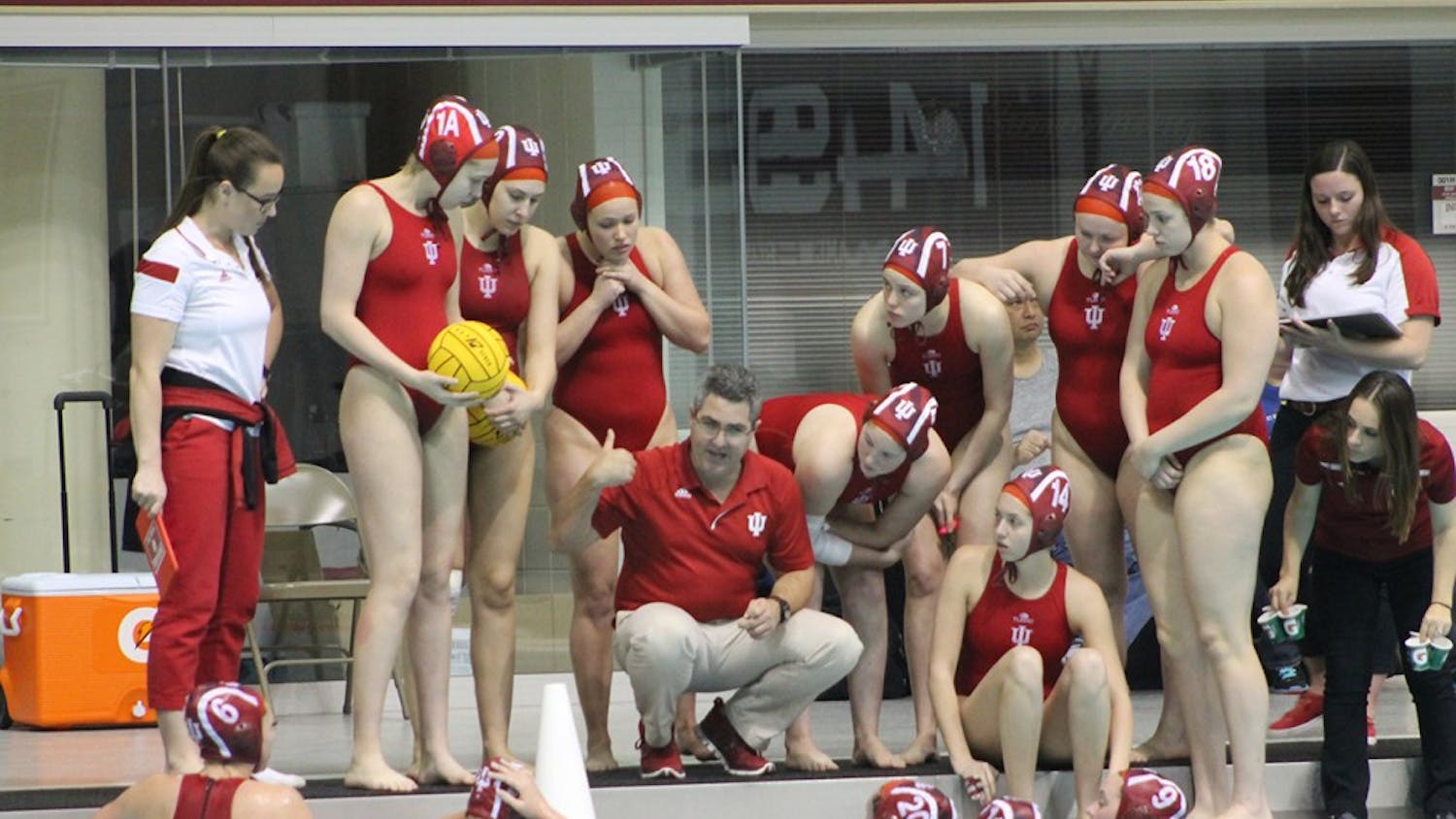 IU head coach Ryan Castle speaks to his team during a timeout in the first quarter. The Hoosiers defeated the Lancers 13-6 Saturday in the Counsilman-Billingsley Aquatics Center.