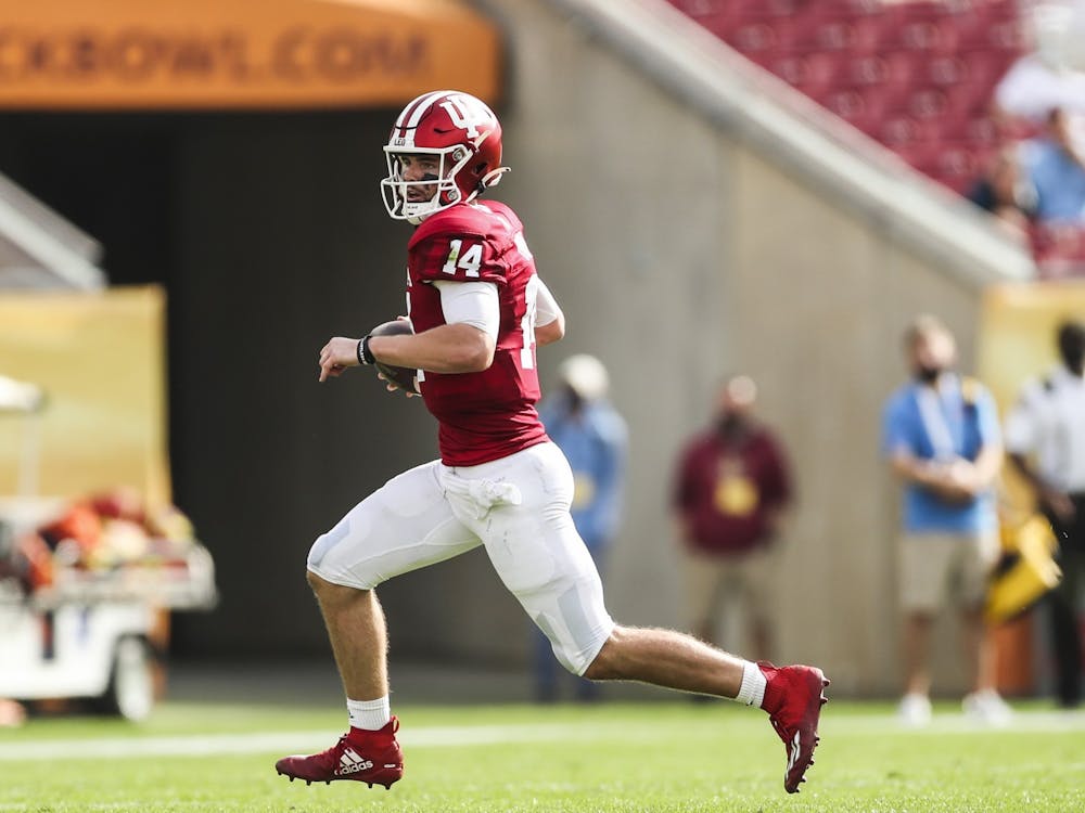 Then-sophomore quarterback Jack Tuttle runs the ball Jan. 2, 2021, at Raymond James Stadium in Tampa, Florida. The Hoosiers will play the Maryland at 3:30 p.m. Oct. 15, 2022, at Memorial Stadium.