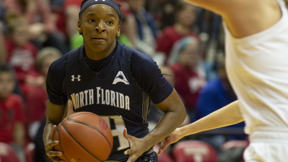 The University of North Florida's Janesha Green looks for an open player Dec. 7 at Simon Skjodt Assembly Hall. Green scored a team high 13 points in North Florida's loss to No. 14 IU.