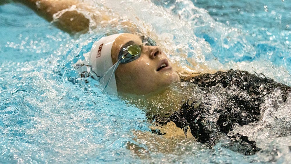 An Indiana swimmer competes in backstroke during a duel meet against University of Cincinnati on Dec. 3, 2021, in the Counsilman-Billingsley Aquatic Center. Indiana swim and dive closed its regular season with a win over Louisville on Friday.