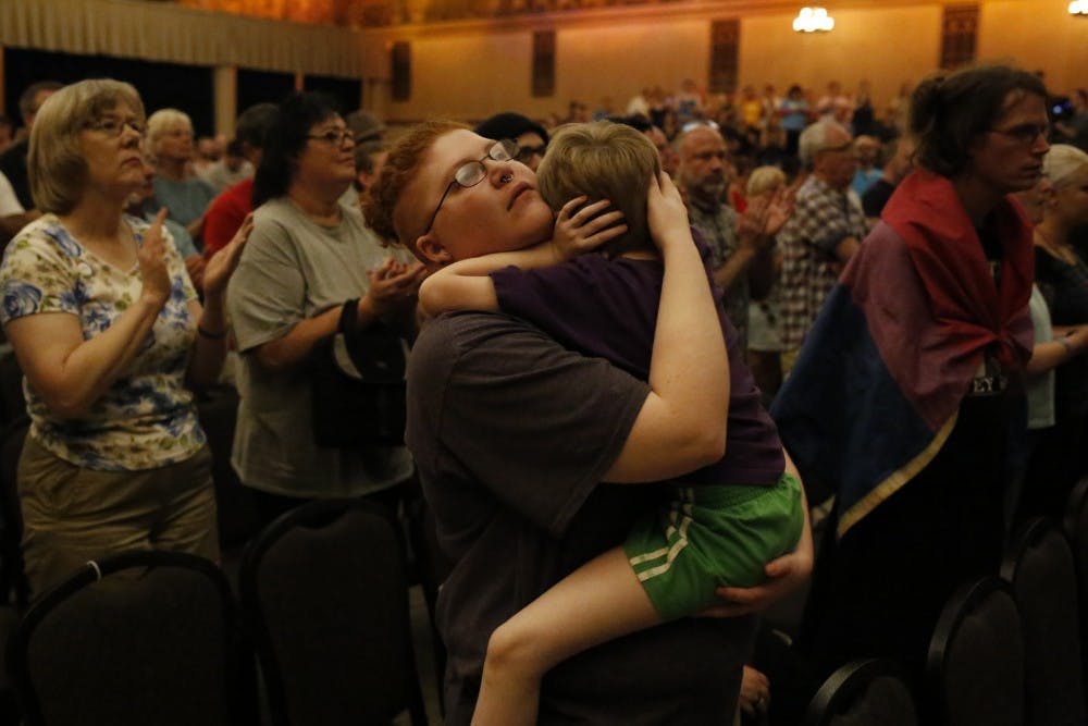 Sebastian Calhoun holds his 6 year old son during a vigil, which took place in the Egyptian Room at the Old National Centre Sunday evening and was sponsored by Indy Pride in response to the recent mass shooting that took place at a gay night club in Orlando, Florida. "I came here for Solidarity," he said. 