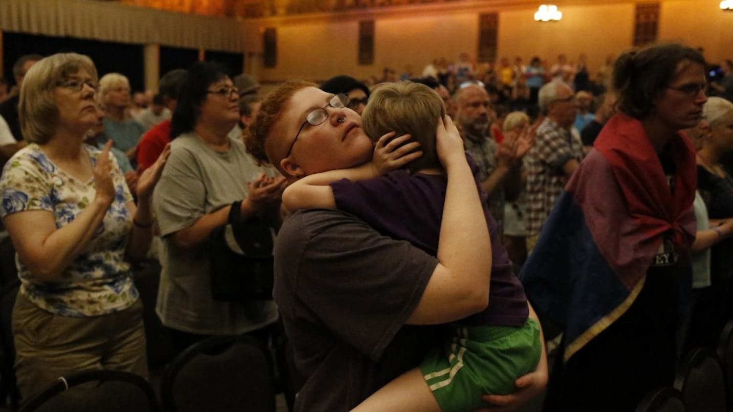 Sebastian Calhoun holds his 6 year old son during a vigil, which took place in the Egyptian Room at the Old National Centre Sunday evening and was sponsored by Indy Pride in response to the recent mass shooting that took place at a gay night club in Orlando, Florida. "I came here for Solidarity," he said. 