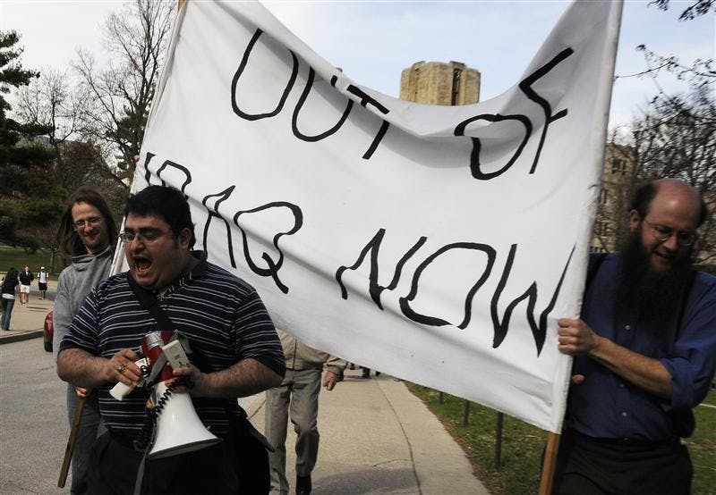 Organizer Ed Vasquez leads an anti-war protest from Woodburn Hall to the Sample Gates on Wedesday near Ballantine Hall. Protesters, many who were from the Indiana Students Against War, marked the six-year anniversary of the U.S. invasion of Iraq.