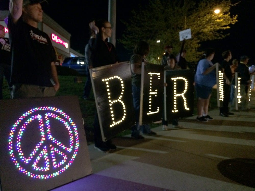 Bernie Sanders' supporters hold lighted signs spelling 'Bernie' on the corner of SR 46 and Third Street Saturday night.