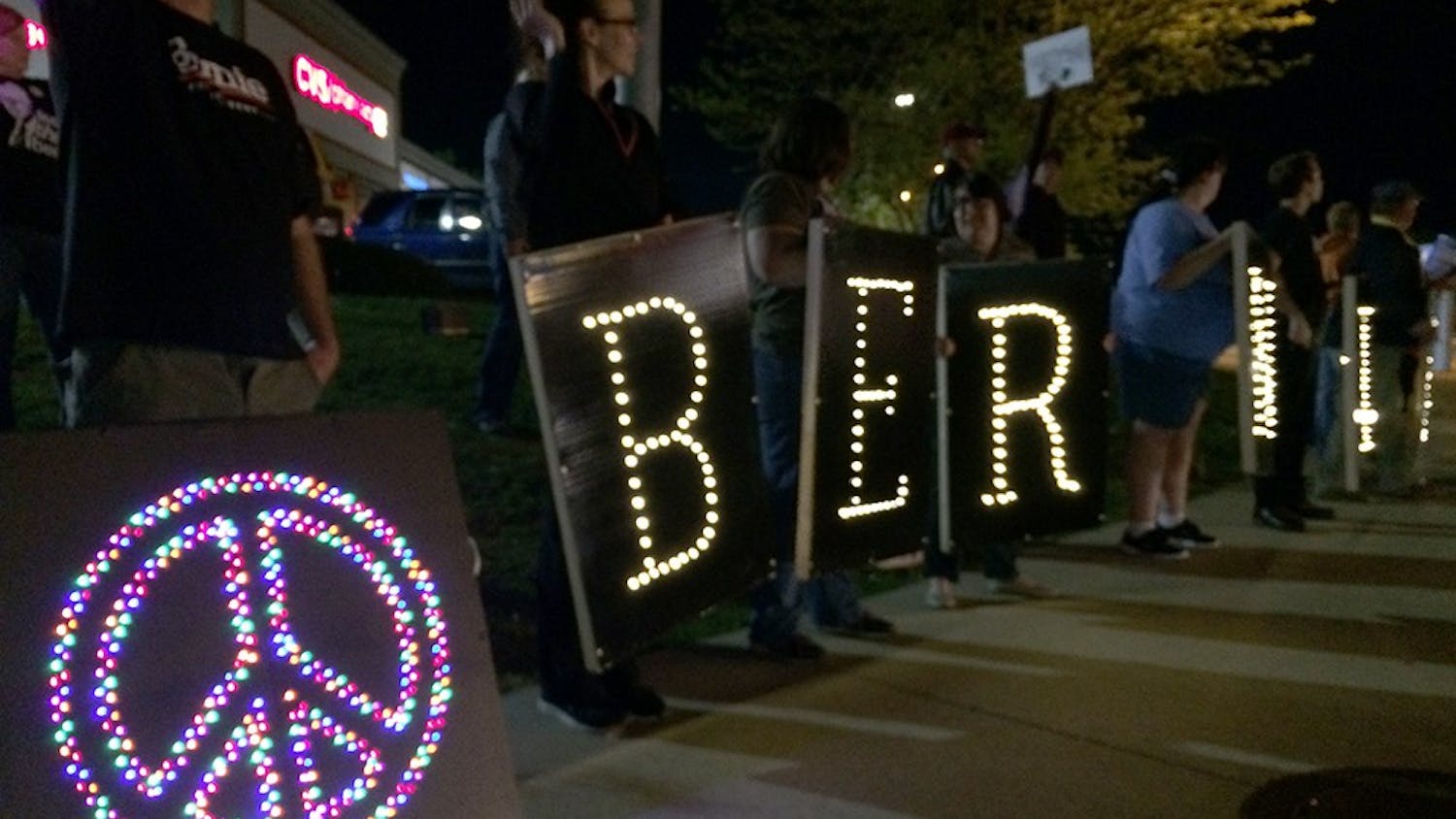 Bernie Sanders' supporters hold lighted signs spelling 'Bernie' on the corner of SR 46 and Third Street Saturday night.