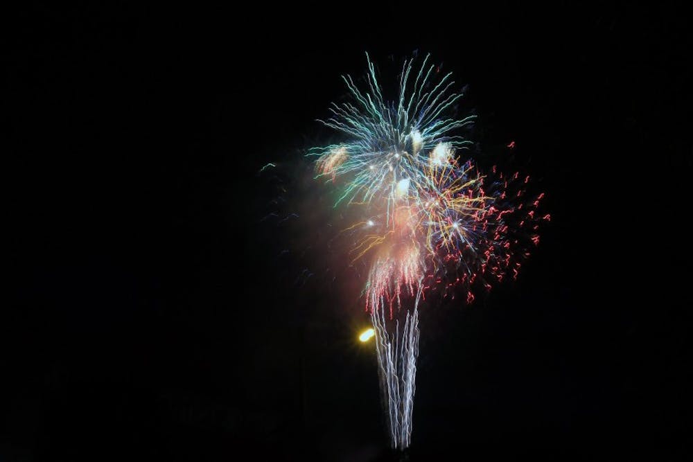 <p>Fireworks are set off from the Trades District July 3, 2018, in downtown Bloomington. Although Indiana has little restriction on fireworks, it is important to follow state and local laws and safety recommendations. </p>