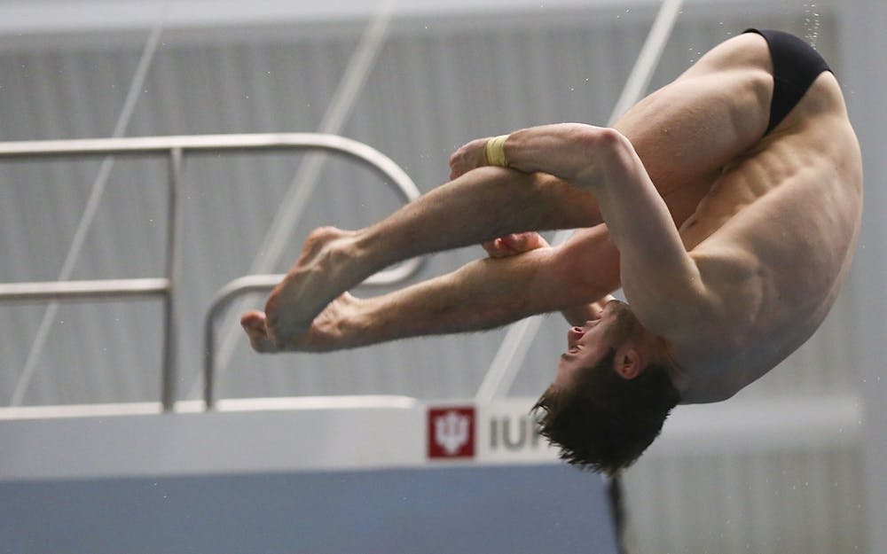 Then-junior Michael Hixon performs a back 2.5 somersault pike at the 2017 NCAA Swimming and Diving championships. Hixon and Andrew Capobianco won silver in 3-meter synchronized springboard diving.
