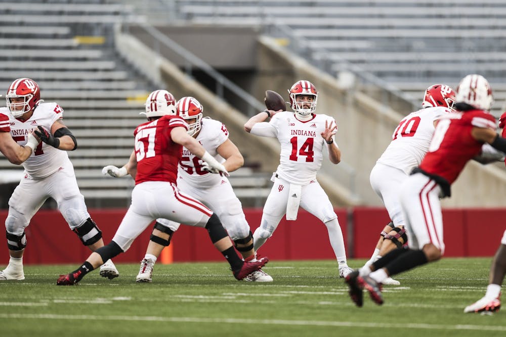 <p>IU quarterback Jack Tuttle tosses the ball during the game Dec. 5 against the Wisconsin Badgers at Camp Randall Stadium in Madison, Wisconsin. IU won 14-6.</p>