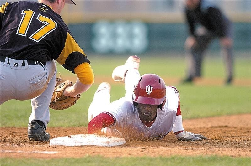 Junior outfielder Evan Crawford dives back to first base after Valparaiso's Ryan O'Gara tries to apply a tag on a pickoff play. Crawford had two hits in the 9-5 Hoosier win.