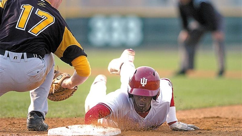 Junior outfielder Evan Crawford dives back to first base after Valparaiso's Ryan O'Gara tries to apply a tag on a pickoff play. Crawford had two hits in the 9-5 Hoosier win.