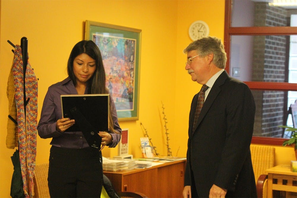 Indiana Attorney General Greg Zoeller presents Victim Advocate with the Middle Way House Monica Hernandez with the Voices for Victims Award Thursday afternoon at the Middle Way House. The award is to recognize Hernandez's dedication to helping and providing a voice to the victims of demostic violence in Indiana.