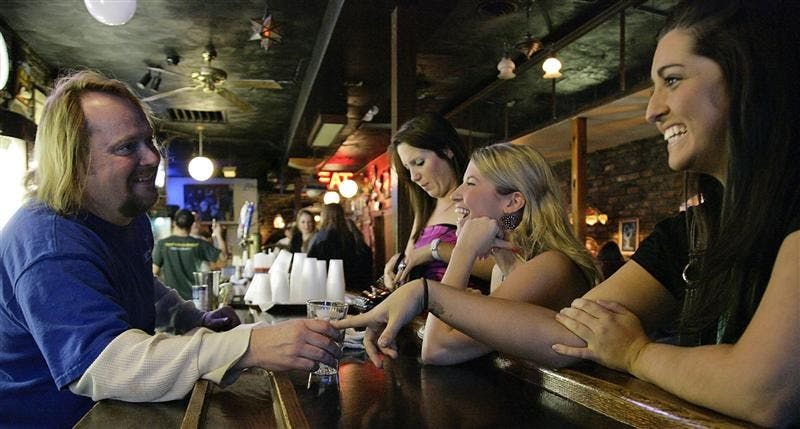 Leo Cook greets fans. Cook has many fans and friends come visit the bar while he's working, and his friendly nature keeps regulars coming back.