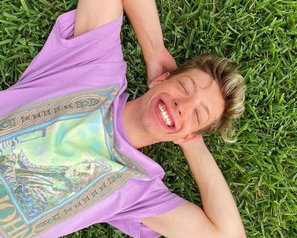 <p>Nate Stratton is seen smiling, laying in the grass. He and his dad, Brad Stratton,  played pickleball this past summer often. “It’s just those little moments,” he said. “I’ve been going to sleep every night thinking about him dancing around the pickleball court with a big smile on his face because he beat me.”</p><p></p>