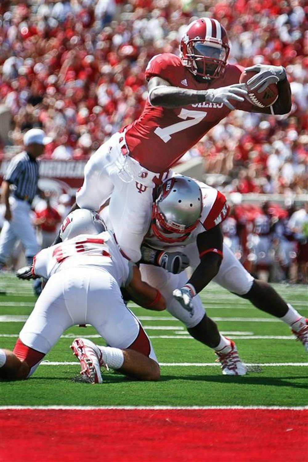 Junior wide receiver Ray Fisher leaps into the end zone over two Western Kentucky defenders during the Hoosiers' 31-13 win against the Hilltoppers Saturday at Memorial Stadium.