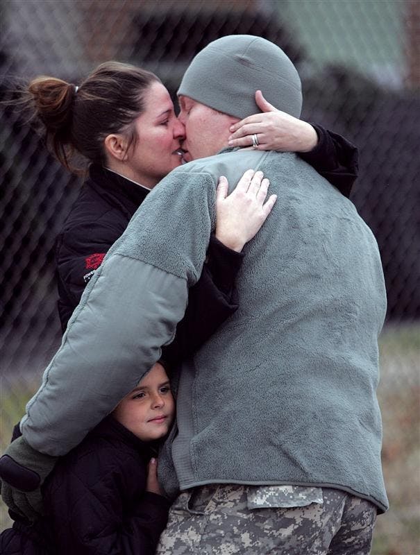 Spc. Marcus Hurtt, 29, of Mishawaka, Ind., says goodbye to his wife Sara, 31, and daughter Chloe, 5, as 120 soldiers from the U.S. Army Reserve's 855th Quartermaster Company in South Bend, Ind., depart on Monday for Fort McCoy in Wisconsin for further training and later deployment to Iraq.  
