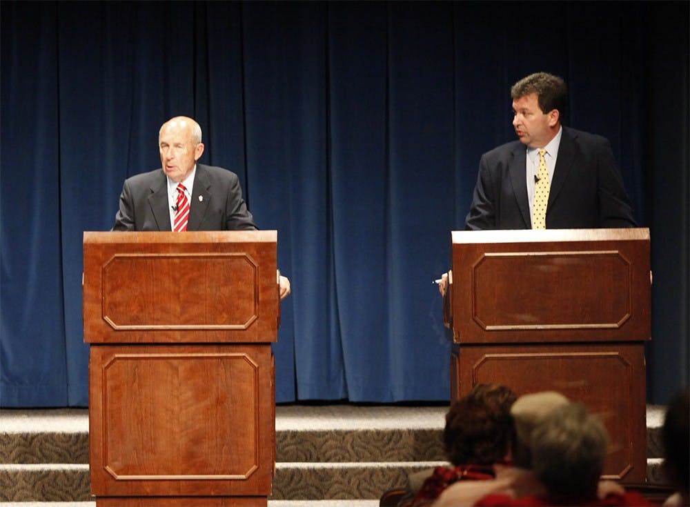  Mike Wilcox, right, listens while Philip N. Eskew Jr. speaks during the question and answer section of the Board of Trustees trustee election forum on June 5.  The chosen candidate will receive the position of Alumni Trustee on the IU Board of Trustees.