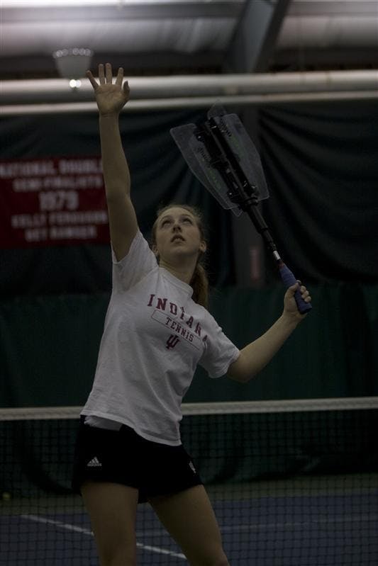 Sophomore Charlotte Martin warms up her serve during practice on Tuesday afternoon at the Varsity Center. Martin and the IU Womens Tennis team have only had four losses this season.