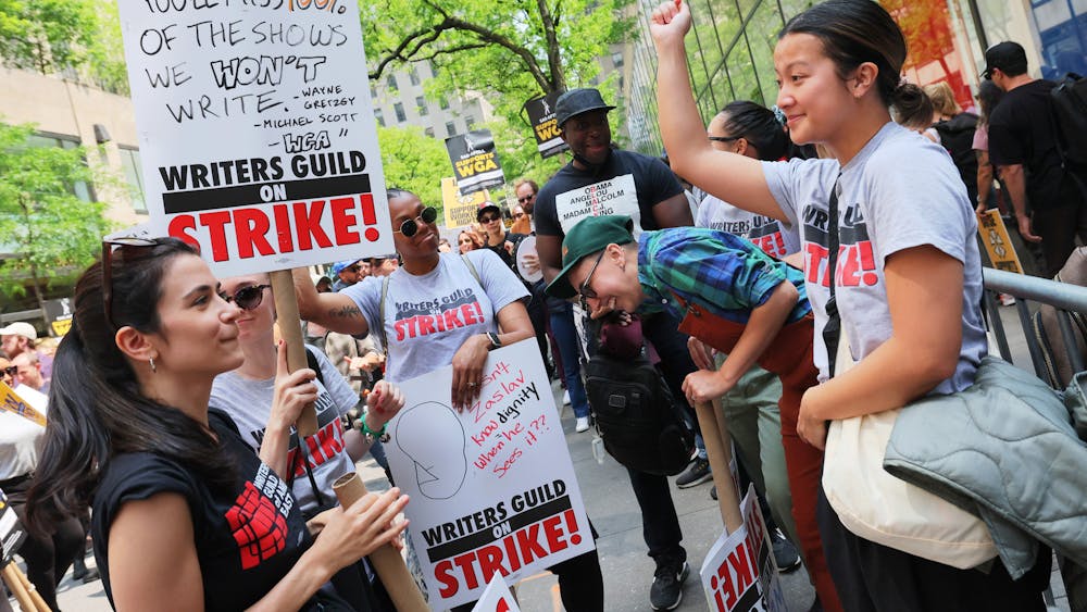 Writers Guild of America (WGA) East members participate in a “Rally at the Rock” strike event outside of the NBCUniversal offices on May 23, 2023, in New York City. The WGA strike has put a spotlight on the entertainment industry’s unfair practices. 