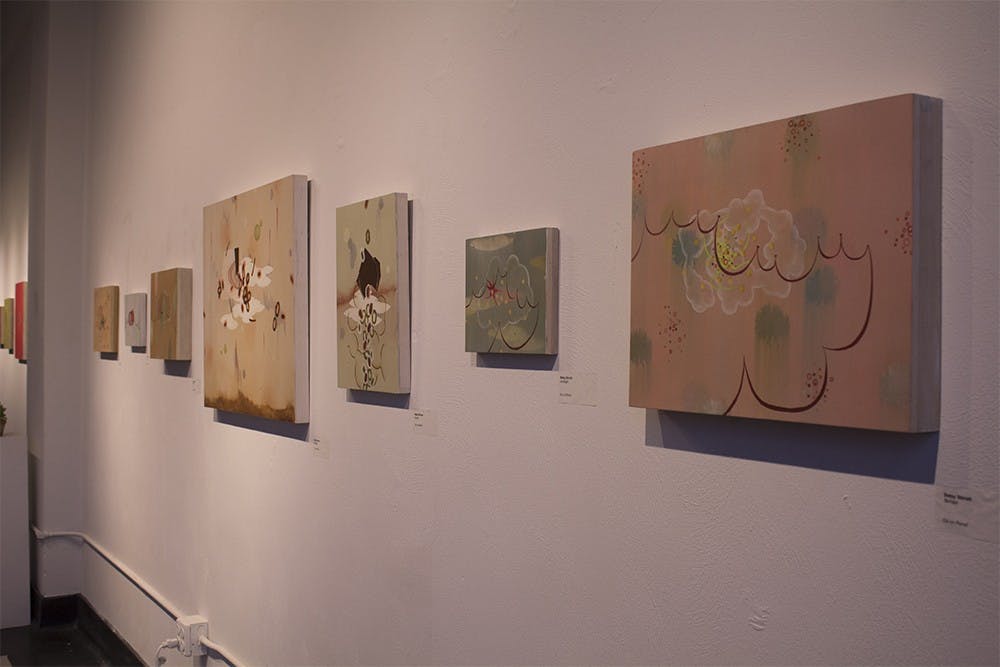 Paintings by Grunwald Direct Betsy Stirratt are displayed in Blueline Gallery on Friday. The works were shown as part of the October Gallery Walk.