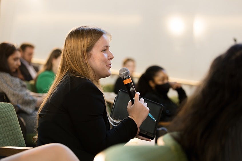 Hamilton Lugar School student Kaitlin Scott asks a question to panelists at the America’s Role in the World conference.