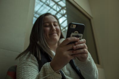 A student looks at her phone March 4 in Franklin Hall.