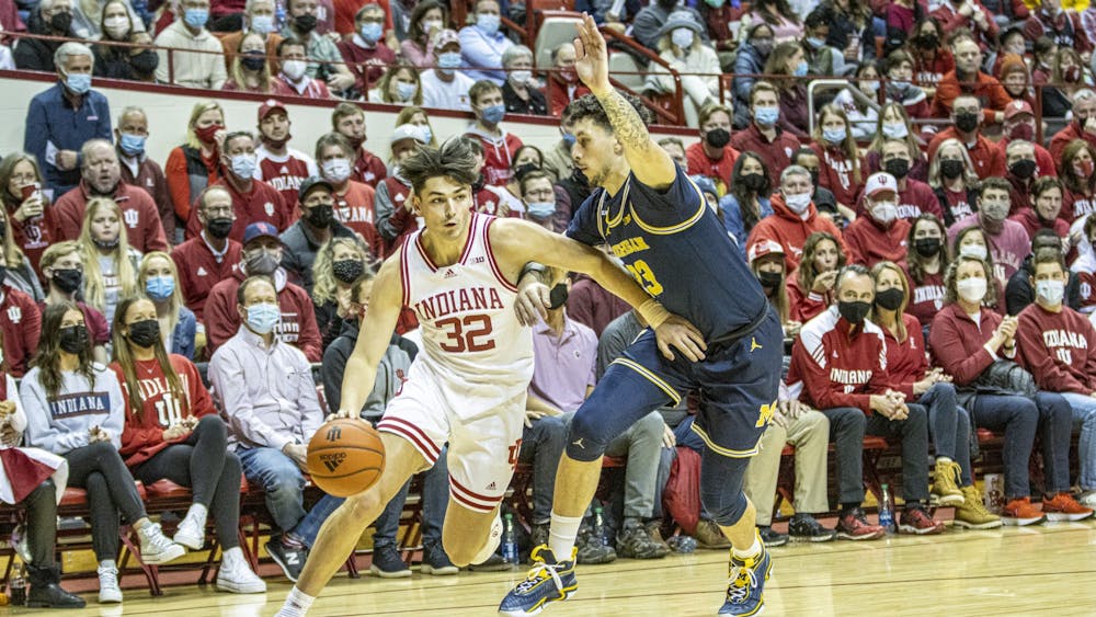 Sophomore guard Trey Galloway dribbles against his Michigan defender on Jan. 23, 2022,at Simon Skjodt Assembly Hall. Indiana will face Michigan at 11:30 a.m. Thursday at the Big Ten Tournament. 