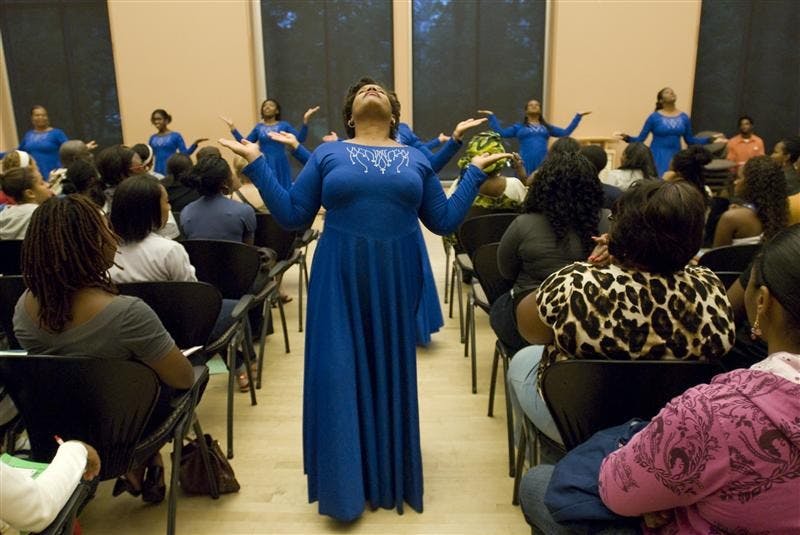 Lisa Freeman (center) performs with Second Baptist Church dance group Heavenly Anointed Vessels Friday evening during the Black Student Orientation in the Neal Marshall Cultural Center Grand Hall. The event offered information booths about organizations around campus, live entertainment, raffle prizes, and educational advice from a panel of successful black students.