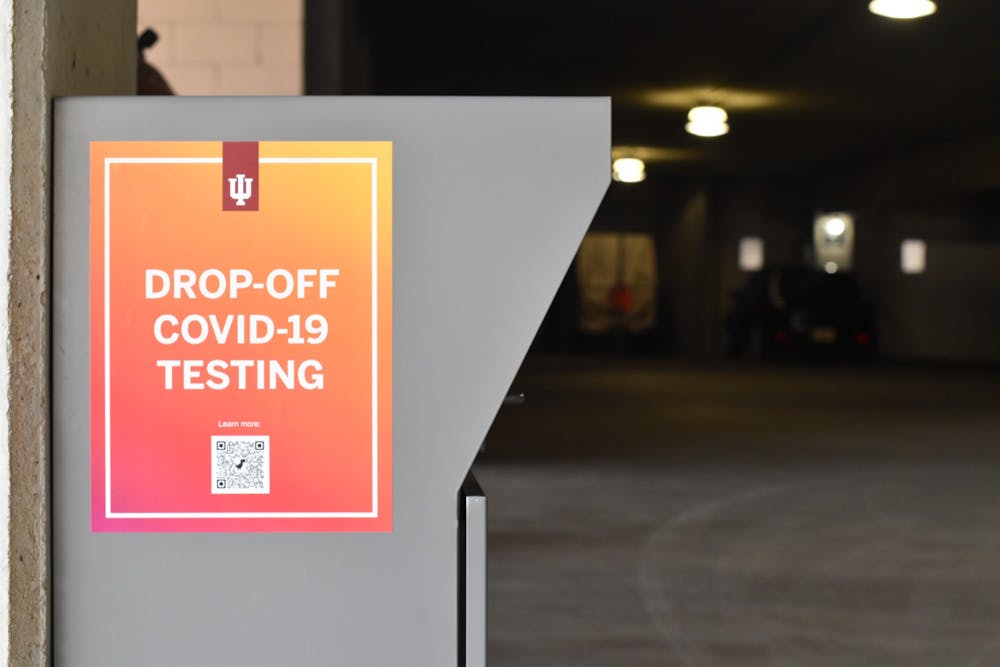 <p>A COVID-19 drop box located in the East Garage is pictured. Test kits are available on campus at drop-off locations.</p>