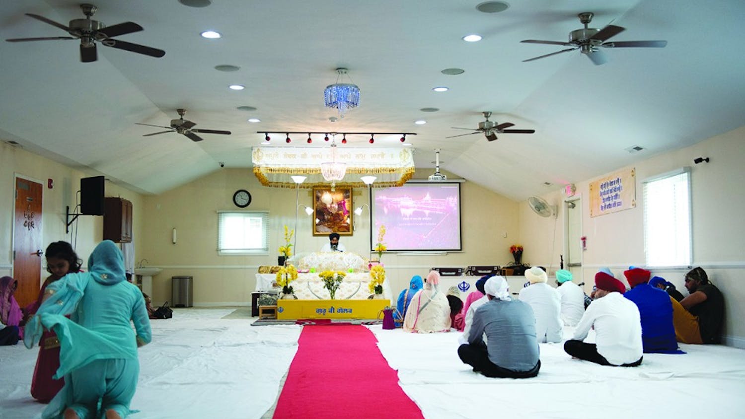 Sikhism practitioners in Fishers, Ind. attending a weekly religious ceremony where words from the Guru Granth Sahib are read. The Holy Book contains passages from the Quran and from the Old Testament. 