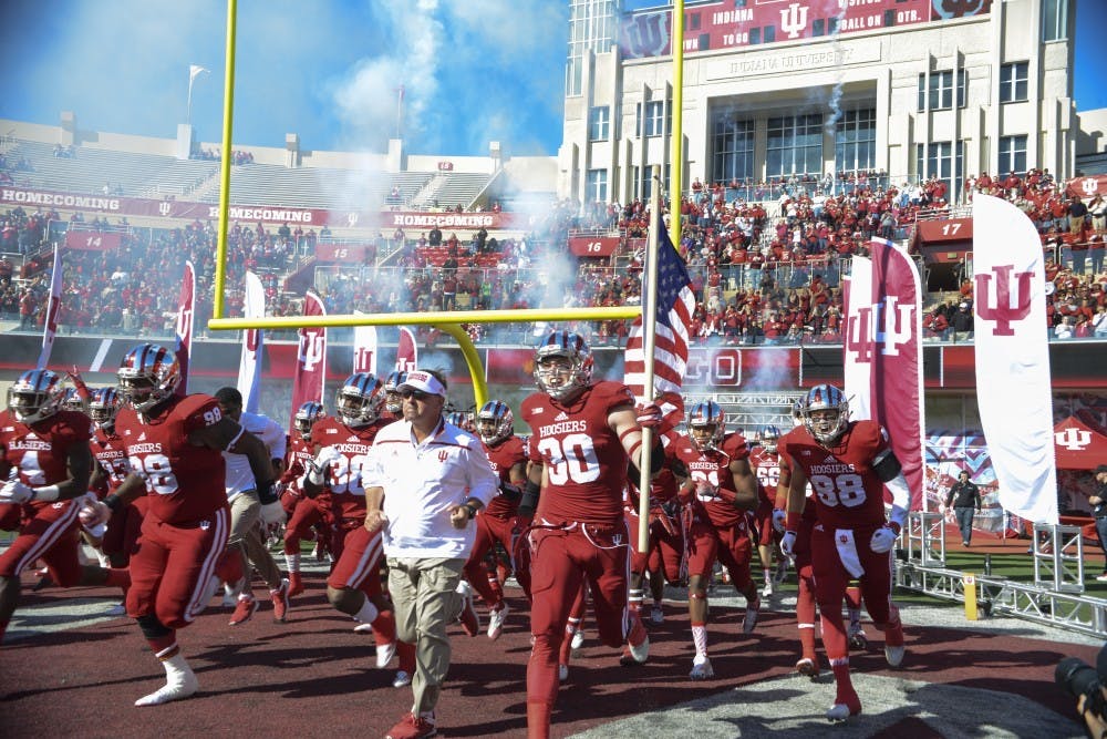 The football team runs onto the field before the game against Rutgers on Saturday at Memorial Stadium. The Hoosiers lost, 52-55.
