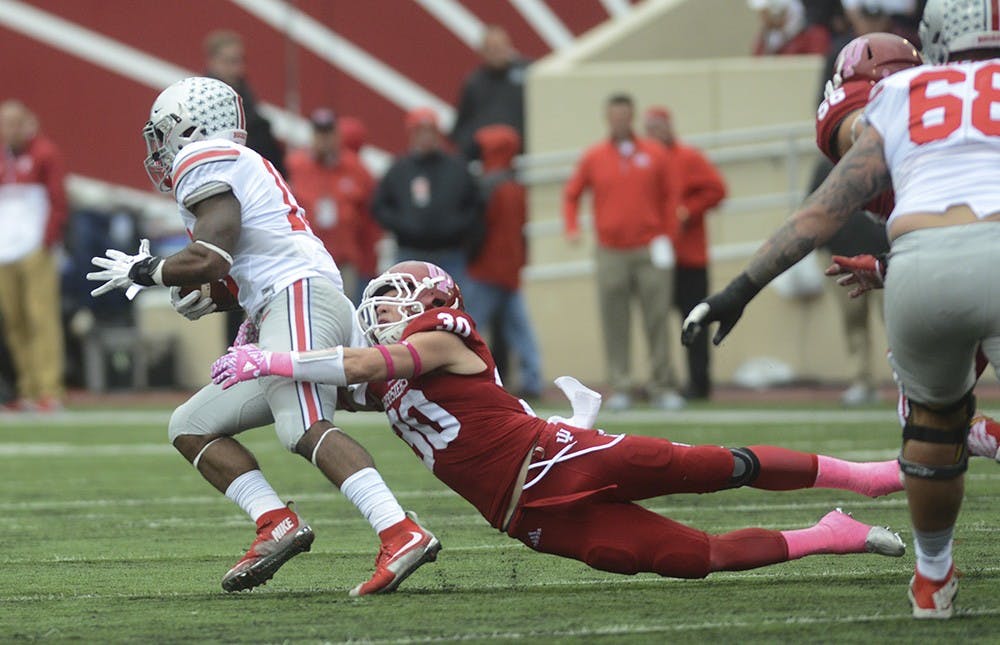 Safety Chase Dutra tackles the runner during the game against Ohio State on Saturday at Memorial Stadium. The Hoosiers lost to the number one ranked Buckeyes, 27-34.