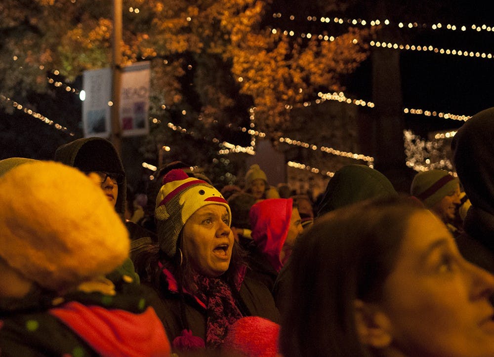 People sing along to christmas carols during the annual Canopy of Lights event Nov. 29, 2013, in front of the Monroe County Courthouse.