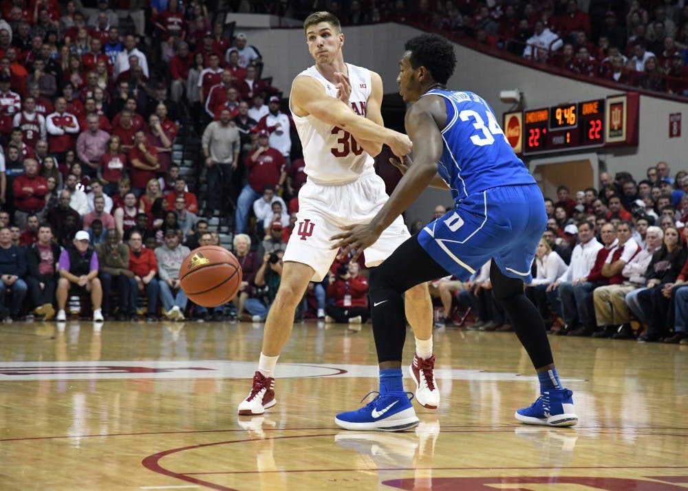 Senior forward Collin Hartman passes the ball against Duke on Wednesday evening in Simon Skodjt Assembly Hall. IU lost its first Big Ten Conference game of the season to Michigan Saturday afternoon.