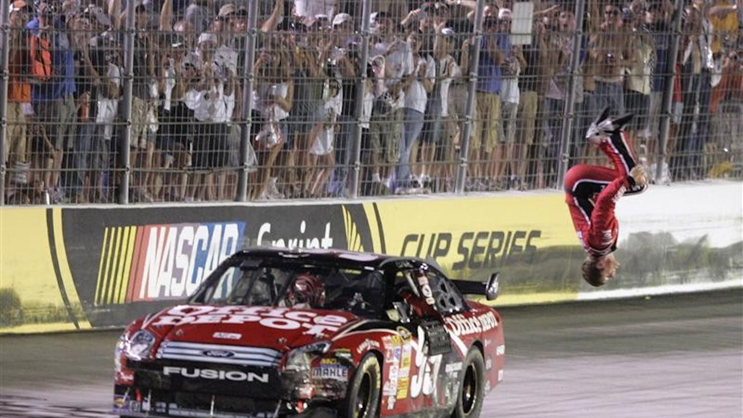 Carl Edwards does his trademark back flip after winning the NASCAR Sprint Cup Series Sharpie 500 auto race Saturday night at the Bristol Motor Speedway in Bristol Tenn.