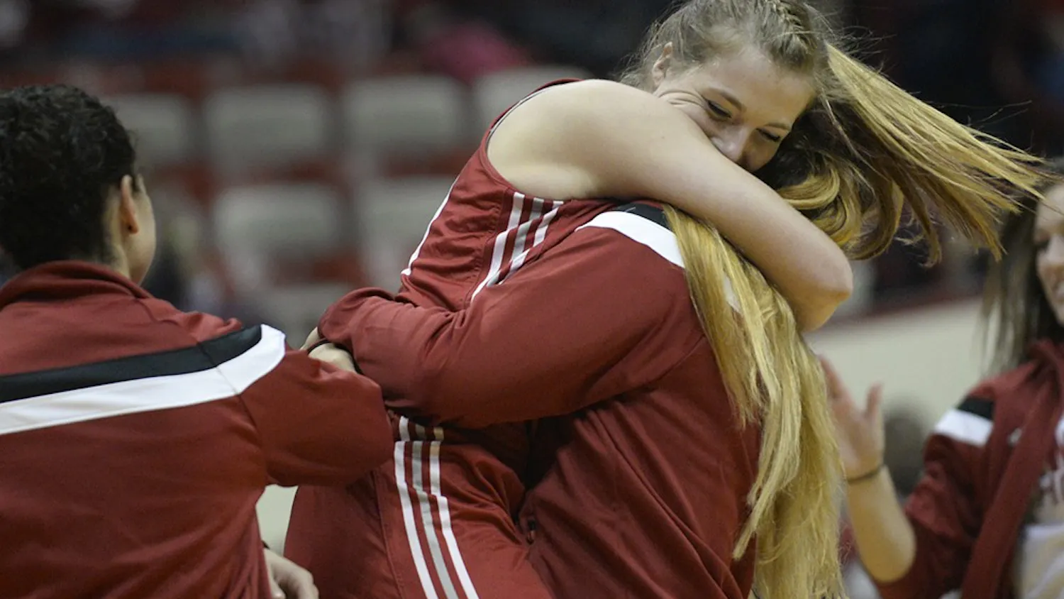 Freshman Mara Muensterman celebrates with teammates after winning the 3-point contest on Saturday during Hoosier Hysteria at Assembly Hall.
