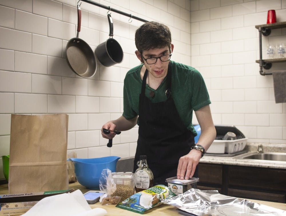 <p>Joe Banchik, 25, is on the autism spectrum. Banchik tests recipes such as a recipe for paleo-friendly granola as seen in the photo for required internship experience at the College Internship Program in Bloomington. </p><p></p>