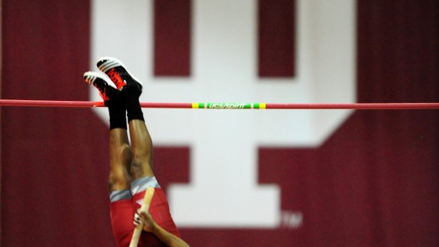 Junior Terry Batemon pole vaults during an event at Gladstein Fieldhouse.