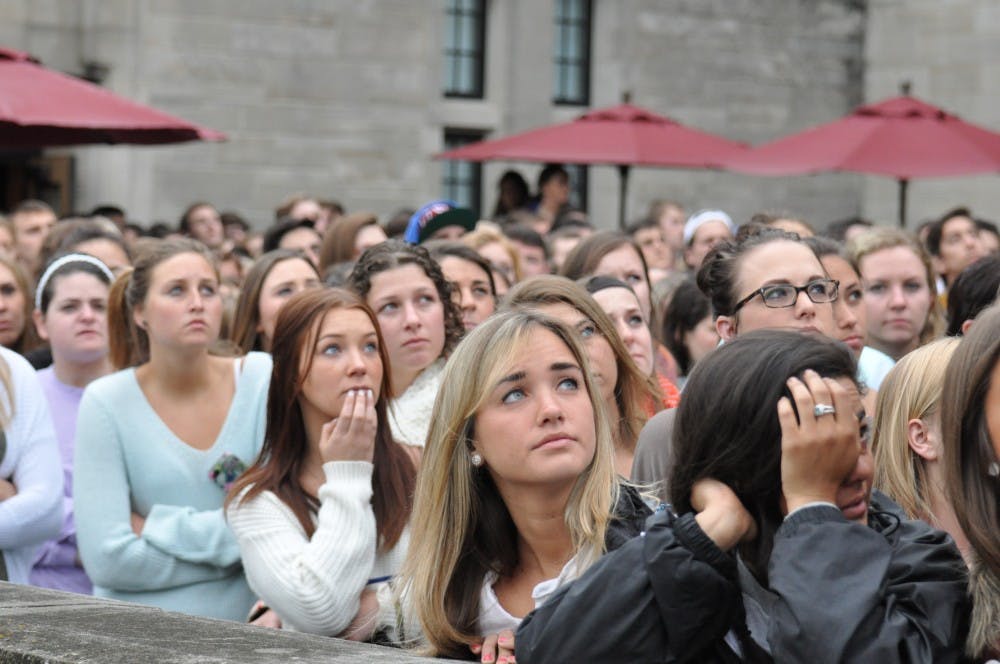 Students watch as balloons are released from the Indiana Memorial Union terrace in memory of Hannah Wilson. The crowd of people who turned out for the vigil was more than Alumni Hall could hold, and crowds of supporters gathered on the terrace and other areas in and around the union.