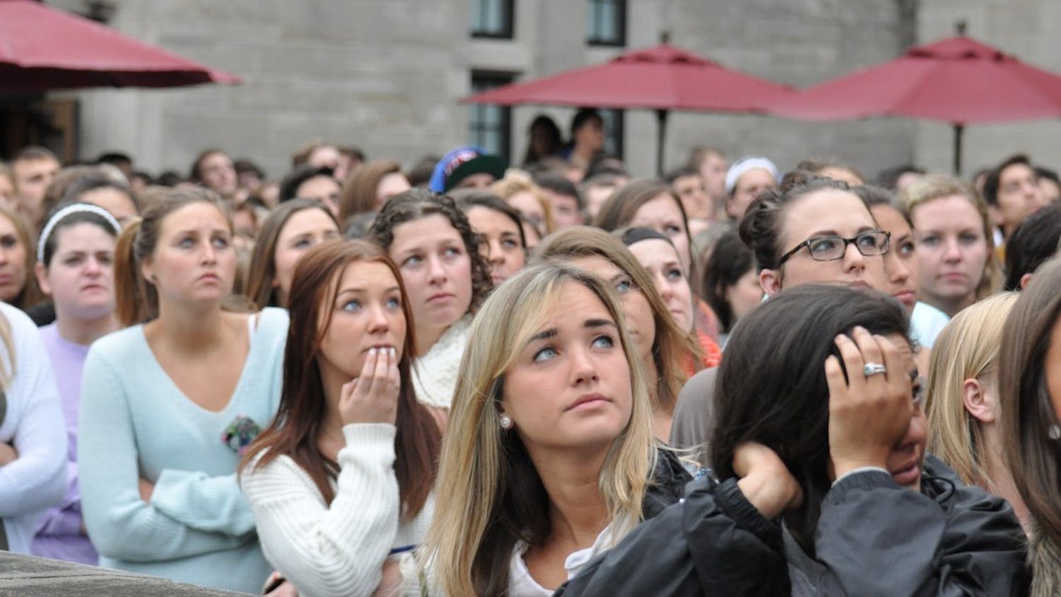 Students watch as balloons are released from the Indiana Memorial Union terrace in memory of Hannah Wilson. The crowd of people who turned out for the vigil was more than Alumni Hall could hold, and crowds of supporters gathered on the terrace and other areas in and around the union.