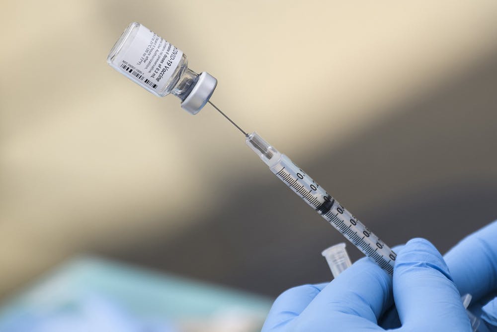 <p>A syringe is filled with a dose of the Pfizer COVID-19 vaccine Aug. 7, 2021, at a mobile vaccination clinic in Los Angeles. Monroe County reported five COVID-19 cases for the week March 6-12.  </p><p> </p>
