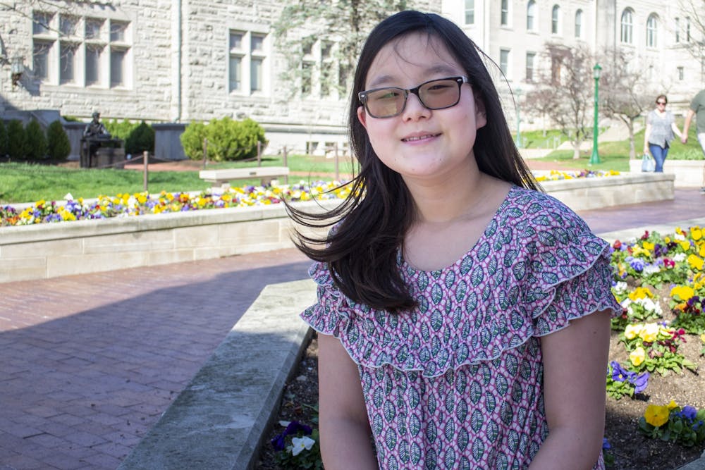 Sixth grade student Yena Park sits March 30 by the Sample Gates. Park has won the IU spelling bee three years in a row. 