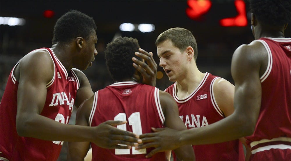 Teammates gather around senior guard Yogi Ferrell after helping him up during the game against Michigan State on Sunday at the Breslin Center in East Lansing, Michigan. The Hoosiers lost 69-88.