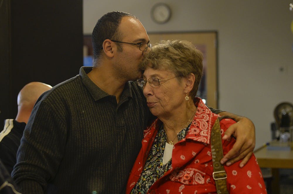 Macabee kisses his mother on the forehead at his son's, Jaxon, birthday party. The support that Macabee has had from his family has been monumental in his struggle to balance his busy life.