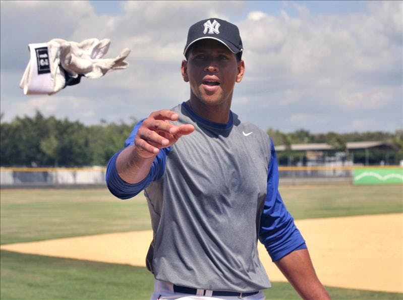 New York Yankees' Alex Rodriguez throws one of his batting gloves to the fans during a practice session with the Dominican Republic baseball team in Boca Chica, Dominican Republic on Tuesday. Rodriguez is joining the Dominican team, to train for the upcoming World Baseball Classic. 