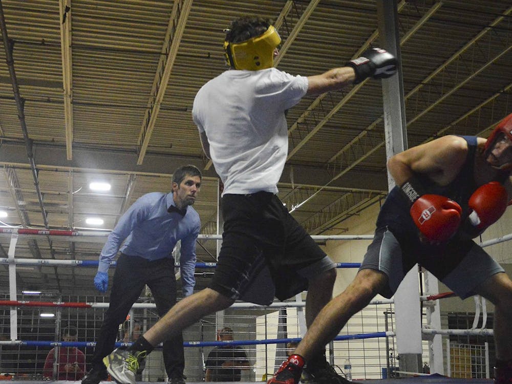 Then-senior Tommy Butler, left, punches his fist towards his opponent during a practice spar in November 2016 at B-Town Boxing. B-Town Boxing will organize an event next week with former world champion boxer Lamon Brewster. 