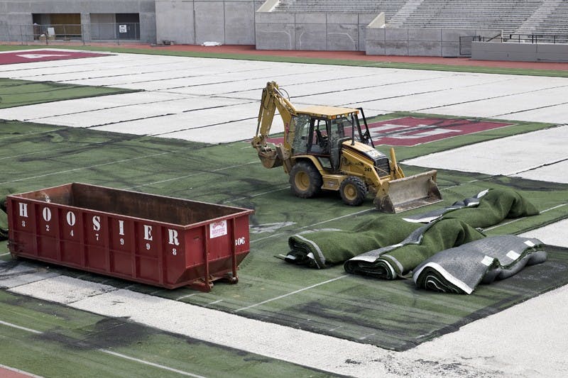 Brandon Foltz / IDSWorkers remove the current Memorial Stadium turf Thursday afternoon. [Ben Homrig at Sports Desk can add more info here].
