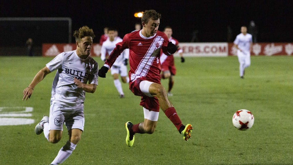 Freshman defender Jack Maher holds off junior Butler midfielder Adam Burch while attempting to win the ball Oct. 16 at Bill Armstrong Stadium. IU defeated Butler, 3-0.