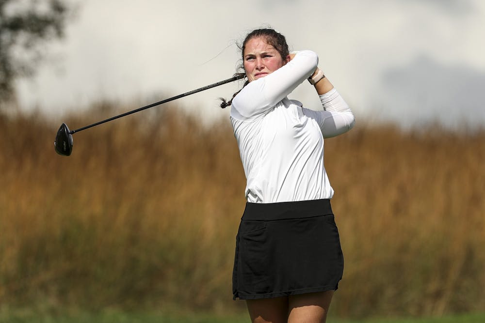 <p>Áine Donegan swings a golf ball at Courtney Cole at Pfau Golf Course in Bloomington. Donegan became the fourth individual in program history to qualify for an NCAA Regional.</p>